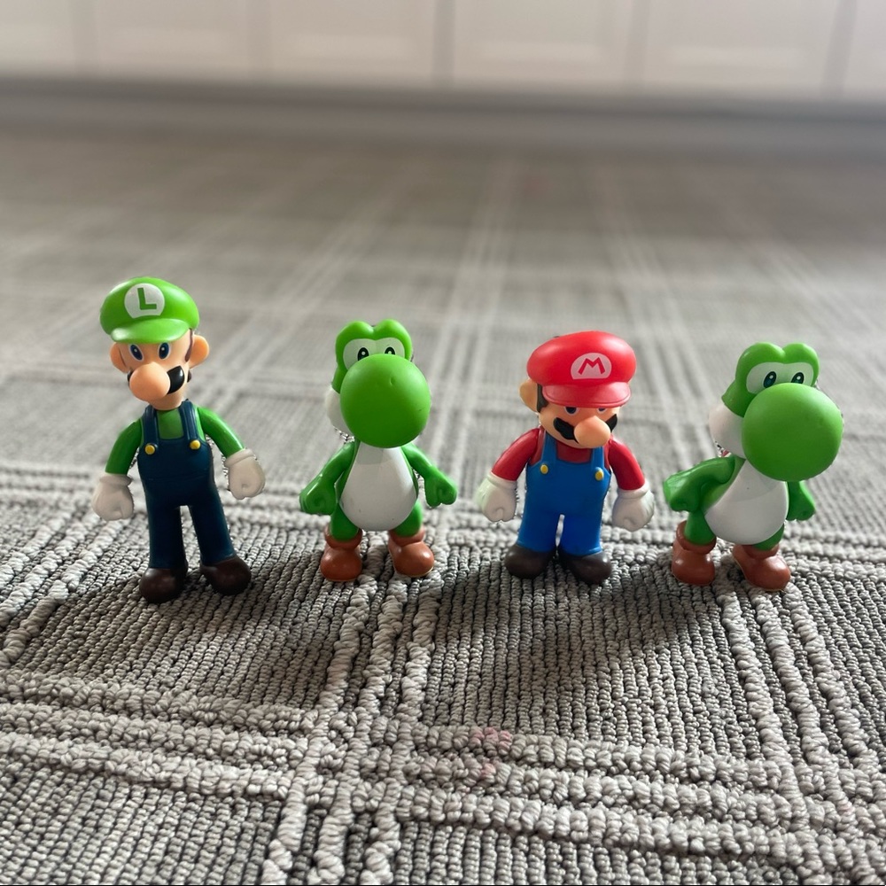Set of 4 Mario Bros figures. Mario, Luigi, and 2 of Yoshi.